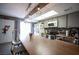 Open concept kitchen features a long breakfast bar, stainless steel appliances, and modern light fixtures at 1843 Mimosa Ct, Henderson, NV 89014