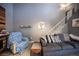 Spacious living room with a gray couch, accent chair, and staircase leading upstairs at 1843 Mimosa Ct, Henderson, NV 89014