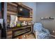 Cozy living room with wood paneling, an electric fireplace, and comfortable seating at 1843 Mimosa Ct, Henderson, NV 89014