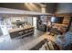 Spacious living area featuring open layout to kitchen, wood plank accent wall, grey walls and modern flooring at 1843 Mimosa Ct, Henderson, NV 89014