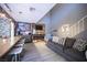 Open-concept living area with grey walls, luxury vinyl floors, wood accent wall, and comfortable seating at 1843 Mimosa Ct, Henderson, NV 89014