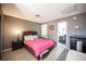 Cozy bedroom featuring laminate floors, a plush bed, and a doorway to the bathroom at 1843 Mimosa Ct, Henderson, NV 89014