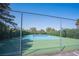 Tennis court featuring a green and blue surface and chainlink fence for privacy at 1843 Mimosa Ct, Henderson, NV 89014