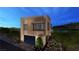 Contemporary home with a glass garage door, desert landscaping, and waterfront views at 20 Lakefront Dr, Henderson, NV 89011