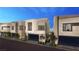 Modern home boasts sleek design, glass garage door, manicured landscaping and inviting curb appeal at 20 Lakefront Dr, Henderson, NV 89011
