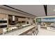 Gourmet kitchen with a marble island, breakfast bar, modern appliances, and an open view to the living area at 20 Lakefront Dr, Henderson, NV 89011