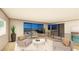 Bright living room with stylish seating, balcony access, and stunning views of the water at 20 Lakefront Dr, Henderson, NV 89011