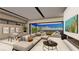 Open-concept living area with a modern fireplace, large sofa, dining table, and scenic lake views at 20 Lakefront Dr, Henderson, NV 89011
