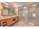 Bathroom featuring double sinks, a large mirror, and a frosted glass shower at 2000 Fashion Show Dr # 4105-4106, Las Vegas, NV 89109