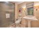 Bathroom featuring a glass-enclosed shower, pedestal sink, toilet, and vanity mirror at 2000 Fashion Show Dr # 4105-4106, Las Vegas, NV 89109