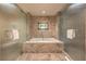 Large marble bathtub set between glass panels with tile surround and silver towel bars at 2000 Fashion Show Dr # 4105-4106, Las Vegas, NV 89109