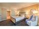 Comfortable bedroom with a king bed, chair, and a view into an ensuite bathroom at 2000 Fashion Show Dr # 4105-4106, Las Vegas, NV 89109
