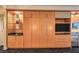 View of the room's built-in cabinetry with glass shelving, cabinets, drawers, and a TV at 2000 Fashion Show Dr # 4105-4106, Las Vegas, NV 89109