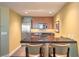 Modern kitchen features a breakfast bar with seating, sleek cabinets, and stainless steel appliances at 2000 Fashion Show Dr # 4105-4106, Las Vegas, NV 89109