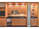 Cozy kitchenette includes stainless steel appliances, wood cabinetry, and sleek countertops at 2000 Fashion Show Dr # 4105-4106, Las Vegas, NV 89109