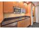 Granite countertops, stainless appliances, wood cabinetry, and tile flooring are featured in the kitchenette at 2000 Fashion Show Dr # 4105-4106, Las Vegas, NV 89109