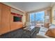 Comfortable living room with large windows showcasing city views, TV, sofa, and built in storage at 2000 Fashion Show Dr # 4105-4106, Las Vegas, NV 89109