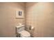 Cozy half bathroom with a toilet, telephone, patterned wallpaper, and framed art at 2000 Fashion Show Dr # 4105-4106, Las Vegas, NV 89109