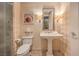Charming bathroom with pedestal sink, elegant lighting, toilet, and tiled flooring at 2000 Fashion Show Dr # 4106, Las Vegas, NV 89109