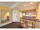 Modern kitchen features wood cabinets, stainless appliances, and a breakfast bar with chairs at 2000 Fashion Show Dr # 4106, Las Vegas, NV 89109