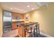 Bright kitchen with stainless steel refrigerator and microwave plus a breakfast bar for seating at 2000 Fashion Show Dr # 4106, Las Vegas, NV 89109