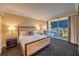 Comfortable main bedroom with city views, soft lighting, and patterned carpet at 2000 Fashion Show Dr # 4106, Las Vegas, NV 89109