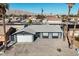 An aerial view of the gray single-story home with a two car garage, desert landscaping and mountain views at 2088 Miner Way, Las Vegas, NV 89104
