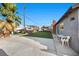 Expansive backyard offers a versatile space for recreation and leisure with a play structure, pool, and ample seating at 2088 Miner Way, Las Vegas, NV 89104