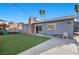 This spacious backyard features a lush lawn, a play structure, and a concrete patio area for outdoor entertaining at 2088 Miner Way, Las Vegas, NV 89104