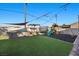 Spacious backyard with a hot tub, play set, and artificial grass at 2088 Miner Way, Las Vegas, NV 89104
