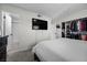 Bright bedroom features a large closet, TV, and adjacent bathroom with tiled shower at 2088 Miner Way, Las Vegas, NV 89104