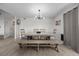 Dining room with wooden table and chairs, neutral paint, wood-look floors, and decorative wall art at 2088 Miner Way, Las Vegas, NV 89104