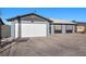 Single story home featuring a gray exterior, a two-car garage, and desert landscaping in the front yard at 2088 Miner Way, Las Vegas, NV 89104