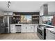 Renovated kitchen features stainless appliances, updated cabinets, black backsplash, and floating wood shelves at 2088 Miner Way, Las Vegas, NV 89104