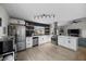 Open kitchen featuring stainless steel appliances, updated cabinets, and access to the living room at 2088 Miner Way, Las Vegas, NV 89104