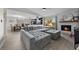 Open floor plan showcases a large gray sectional, fireplace, kitchen, and dining room for easy entertaining at 2088 Miner Way, Las Vegas, NV 89104