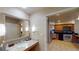 Modern bathroom with granite countertop and adjacent kitchenette at 211 E Flamingo Rd # 202, Las Vegas, NV 89169
