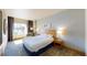 Bright bedroom featuring a large window with city views, a comfortable bed, and modern decor at 211 E Flamingo Rd # 202, Las Vegas, NV 89169