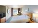 Well-lit bedroom showcasing a bed, window with city views, and a chest of drawers at 211 E Flamingo Rd # 202, Las Vegas, NV 89169
