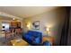Comfortable living room with blue sofa and chairs, adjacent to a kitchen bar area at 211 E Flamingo Rd # 202, Las Vegas, NV 89169