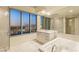 Bright bathroom featuring a soaking tub, spacious vanity, and a large window with a city view at 222 Karen Ave # 1702, Las Vegas, NV 89109