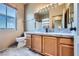 Bathroom with a toilet, sink with wood cabinets, and granite countertops at 2325 Windmill Pkwy # 1622, Henderson, NV 89074