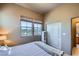 Bedroom with view of landscape featuring large window, closet and queen bed at 2325 Windmill Pkwy # 1622, Henderson, NV 89074