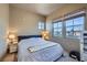 Bedroom with view of landscape featuring two side tables with lamps and queen bed at 2325 Windmill Pkwy # 1622, Henderson, NV 89074
