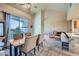 Open floor plan with dining area featuring wood table and chairs, leading to the living room at 2325 Windmill Pkwy # 1622, Henderson, NV 89074