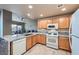 Bright kitchen features stainless steel appliances and granite countertops and wood cabinets at 2325 Windmill Pkwy # 1622, Henderson, NV 89074