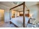 Spacious main bedroom with a four-poster bed, bedside tables and carpeted floors at 2325 Windmill Pkwy # 1622, Henderson, NV 89074