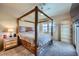 Primary bedroom featuring a four-poster bed, ceiling fan, and side table at 2325 Windmill Pkwy # 1622, Henderson, NV 89074