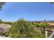 A view of the neighborhood with beautiful landscaping, rooftops, and mountains in the distance on a clear day at 2325 Windmill Pkwy # 1622, Henderson, NV 89074