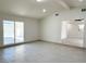 Open-concept living space with sliding glass doors leading to the backyard, complemented by sleek tile flooring at 236 Pershing Dr, Las Vegas, NV 89107